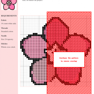 Cross stitch pattern of pink oleander blossoms. The design features detailed stitching and uses shades of pink and red.