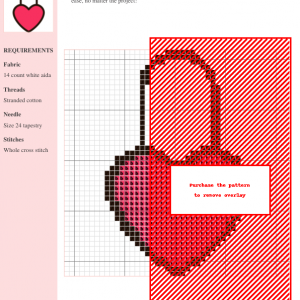 Cross-stitch pattern featuring a padlock design with a heart, predominantly in red and black, on a white aida cloth.