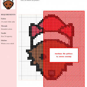 Cross-stitch pattern of a cute wolf wearing a Santa hat, predominantly brown and red, on a white aida fabric.