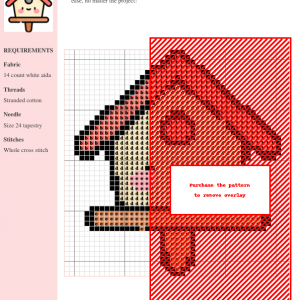 Cross stitch pattern of a cute birdhouse in red and beige tones on a white aida fabric.
