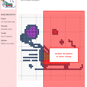 A cross-stitch pattern depicting a charming sled, featuring a blend of dark blue, purple, red, and green threads on white aida cloth.
