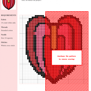 Cross stitch pattern of a red anthurium flower. The design features various shades of red and pink, and uses whole cross stitches.
