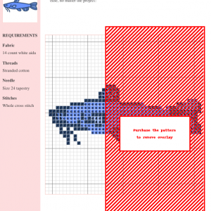 Cross-stitch pattern depicting a catfish, using shades of blue and black on white aida cloth. Part of the design is obscured by a red overlay.