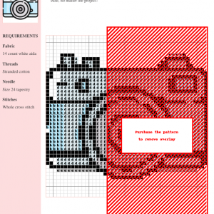 A charming cross-stitch pattern depicting a light blue vintage-style photo camera. Perfect for needlepoint enthusiasts.