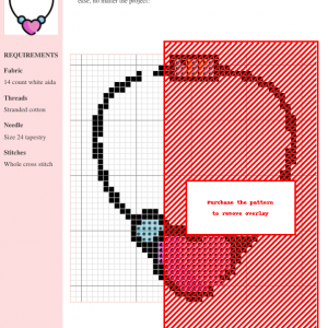 Image of a cross stitch pattern depicting a necklace with a pink heart charm and light blue beads.