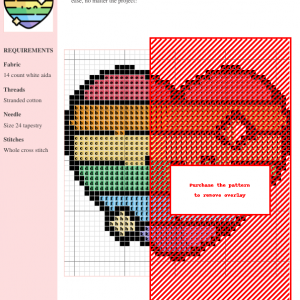 Image of a cross stitch pattern featuring a rainbow-striped heart with sparkling details. A cute, smiling face is subtly incorporated into the design.