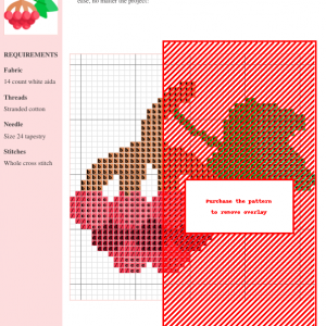 Image of a cross stitch pattern featuring a cluster of red berries with a green leaf and stem.