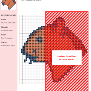 Cross stitch pattern design featuring a charming, stylized squirrel head in shades of orange and brown.