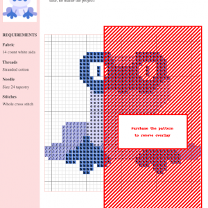 Cross stitch pattern featuring a cute, cartoonish frog in shades of light purple and blue. The frog wears a mask-like design around its eyes.