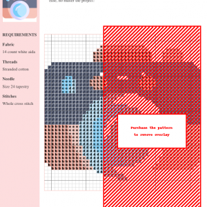 Cross stitch pattern design of a cute cartoon camera with blush cheeks and a smiling face. Colors include peach, gray, and light blue.