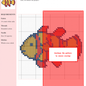 Image of a charming clownfish cross stitch pattern design featuring orange and red stripes on a yellow body.