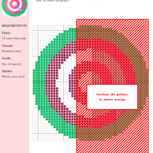 Image of a cross-stitch pattern depicting a dartboard with an arrow hitting the center, in pink, white, and green.