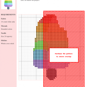 A vibrant cross stitch pattern depicting a rainbow-colored popsicle with a bite taken out of it.