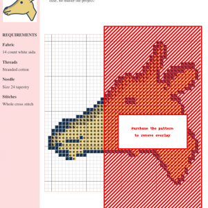Close-up of a cross-stitch pattern featuring a charming giraffe's head, rendered in pale yellow and dark blue thread.