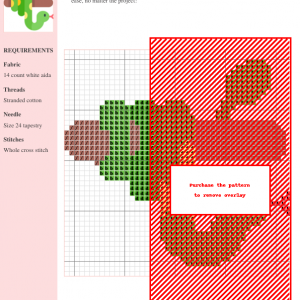 Cross stitch pattern featuring a green snake wrapped around a brown branch. The snake has yellow spots and a red tongue.