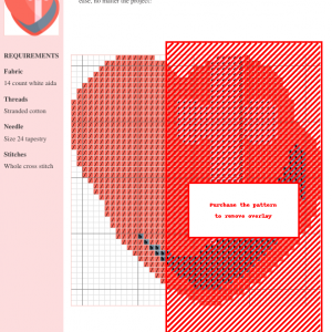 Cross stitch pattern depicting a heart-shaped gift box with a pink bow, ready to be stitched.
