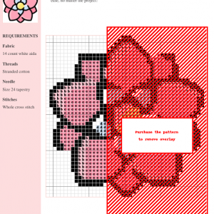 Image of a Dahlia cross stitch pattern featuring a pink flower with light blue and yellow center. Perfect for beginner to intermediate stitchers.